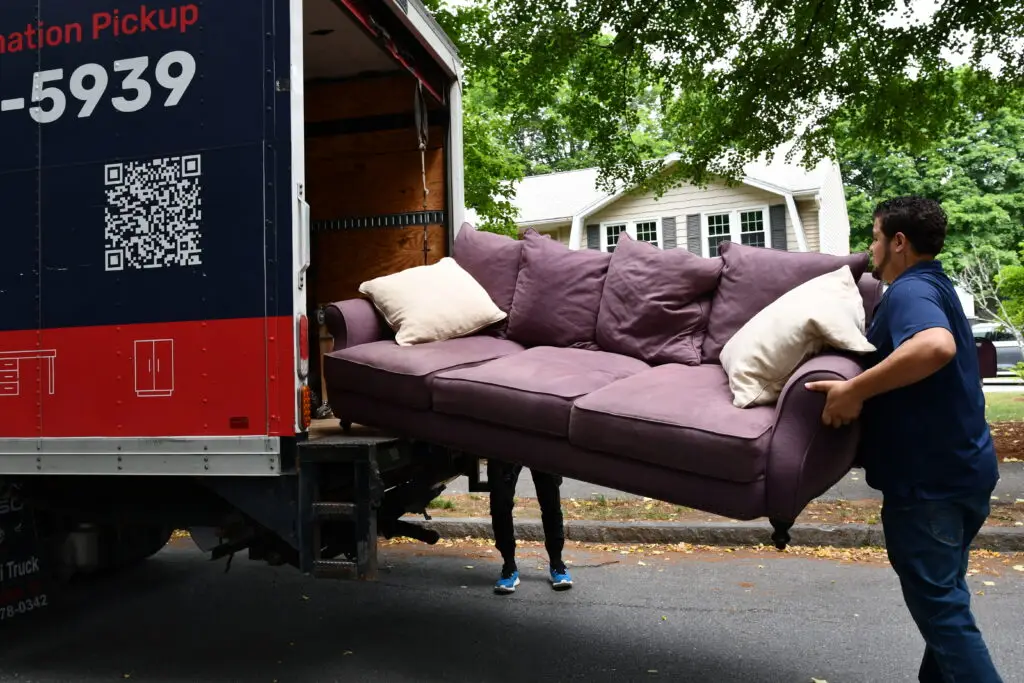 Two men moving couches