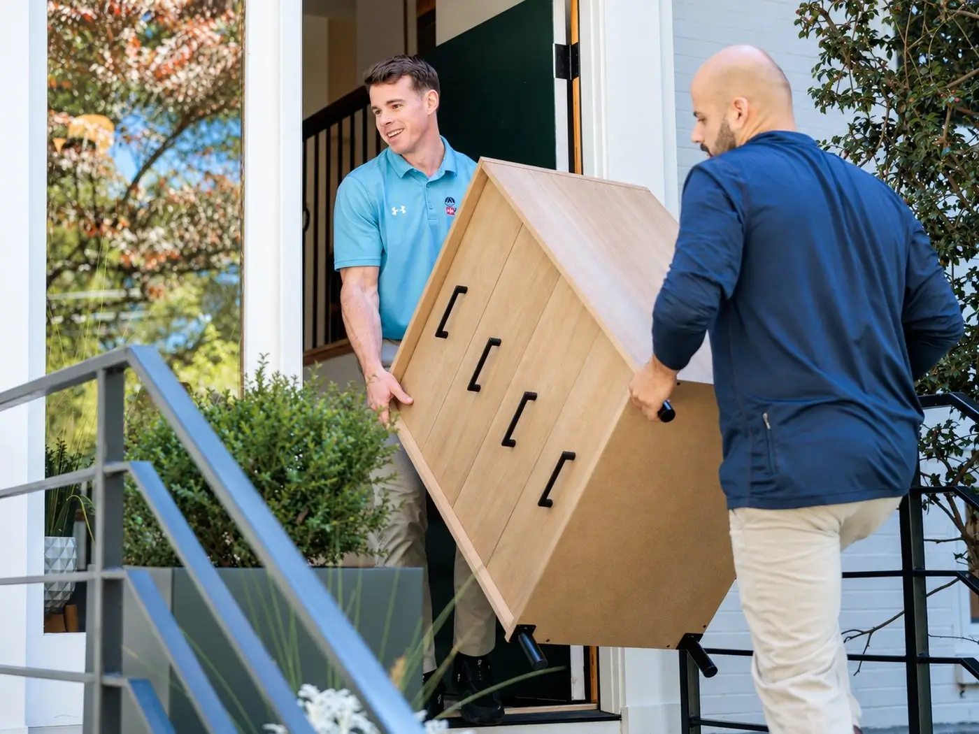 Furniture donation pickup, vetted team carrying furniture out for a local charity